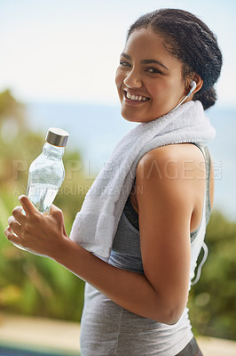 Buy stock photo Woman, portrait or water with headphones in nature for exercise, listening or streaming for workout. Female runner, natural smile or bottle for training by ocean, trail running in Brazil for wellness