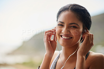 Buy stock photo Woman, portrait or smile with headphones in nature for exercise, listening or streaming for workout. Female runner, happiness and hands for training by ocean, trail running in Brazil for wellness