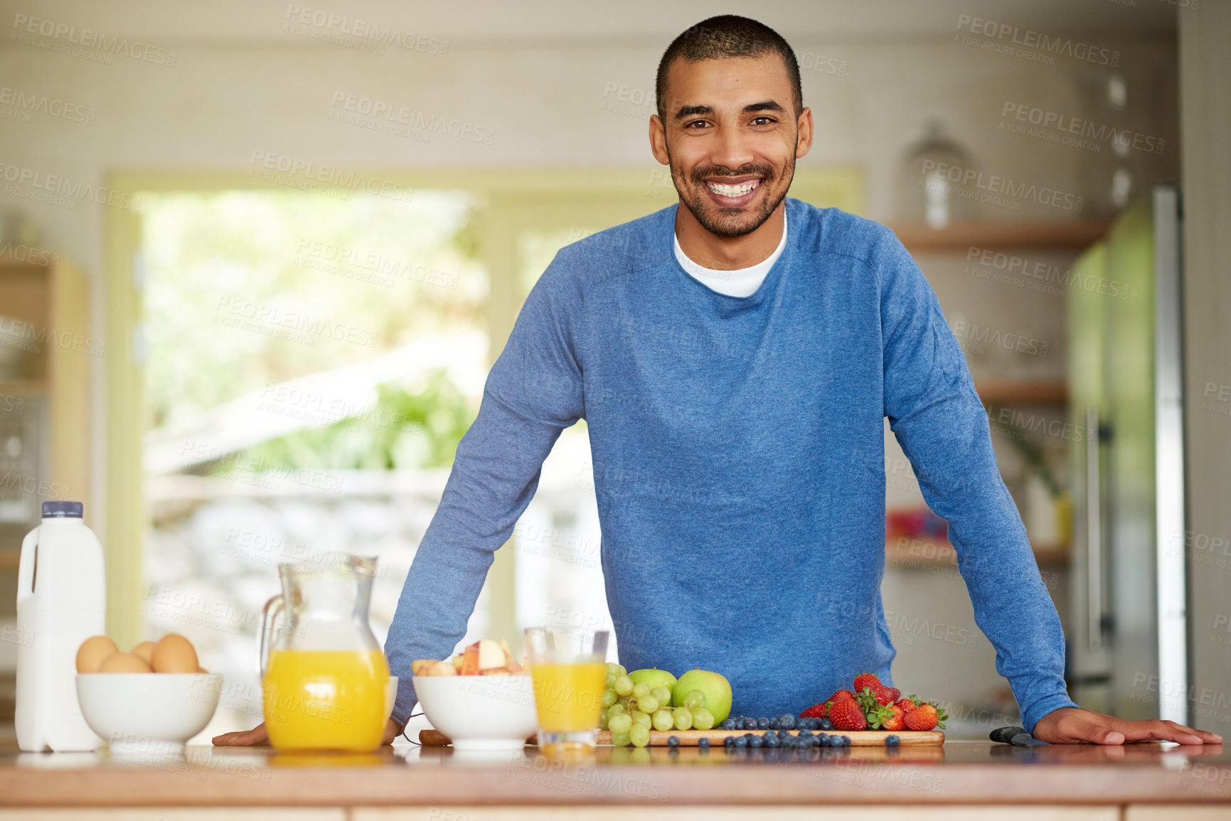 Buy stock photo Man, portrait and healthy fruit for breakfast nutrition or meal prep as gut health, wellness or antioxidants. Male person, face and smile at kitchen counter with orange juice or organic, eggs or home