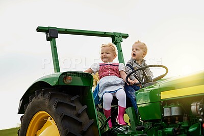 Buy stock photo Children, driving and tractor on farm in outdoor with farming transport, sustainable and learning field work for development. Girl, boy and countryside fun for farmer machinery in training for growth