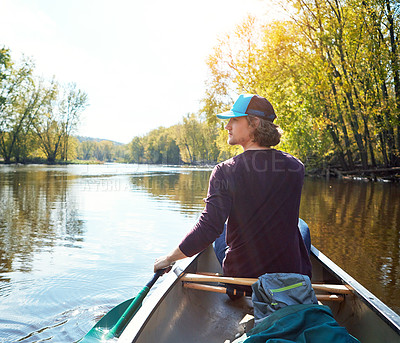 Buy stock photo Man, canoeing and lake rowing in woods for morning adventure for exercise, exploring or island. Male person, river and Colorado traveling for outdoor hobby with boat at camp site, forest or nature