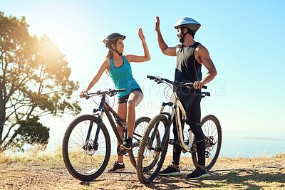 Buy stock photo Outdoor, people and high five in mountain bike by nature for celebration, achievement and training goal. Happy couple, man and woman with bicycle for fitness, workout and sports success in Germany