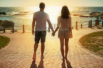 Buy stock photo Beach, holding hands and couple with love, summer and vacation for honeymoon, romance and getaway trip. Outdoor, seaside and man with woman, lens flare and adventure with support, travel and journey