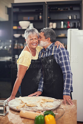 Buy stock photo Cooking, kiss and senior couple in kitchen at home with dough, flour and ingredients for meal. Happy, food and elderly man and woman preparing dinner, lunch or supper together at house in Mexico.