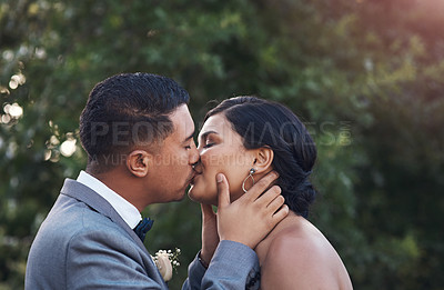 Buy stock photo Happy, couple and kiss on wedding day as celebration for love, commitment and success on marriage. Ceremony, woman and man at event as engagement reception together, support and care in sunshine
