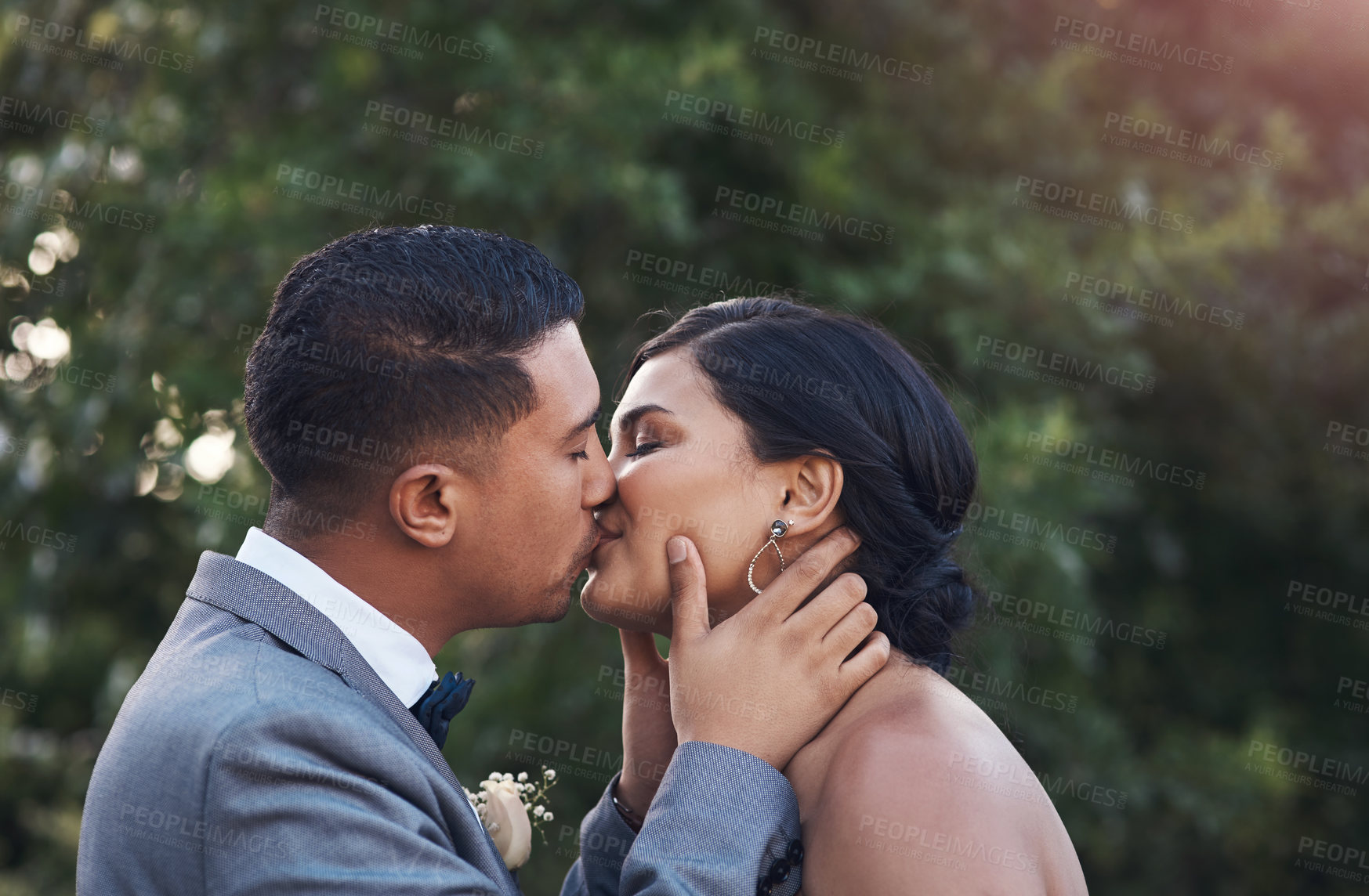 Buy stock photo Happy, couple and kiss on wedding day as celebration for love, commitment and success on marriage. Ceremony, woman and man at event as engagement reception together, support and care in sunshine
