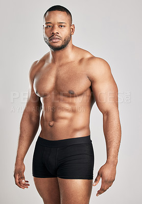 Buy stock photo Portrait, black man and muscle in studio with underwear for fitness or health with confidence for body. Strength, serious and ready for bodybuilding competition in Germany with power training.
