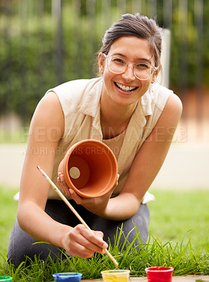 Buy stock photo Ceramic, pot and portrait of girl painting a craft container for plant in garden with creativity in hobby. Clay, art and artist with inspiration outdoor with paint brush, decoration or fun project