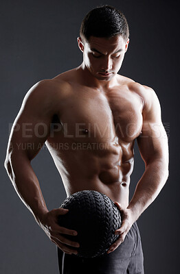 Buy stock photo Ball, bodybuilder or strong man in studio for workout, training or exercise for power or strength. Black background, fitness or topless athlete with equipment for arms, sports challenge or wellness