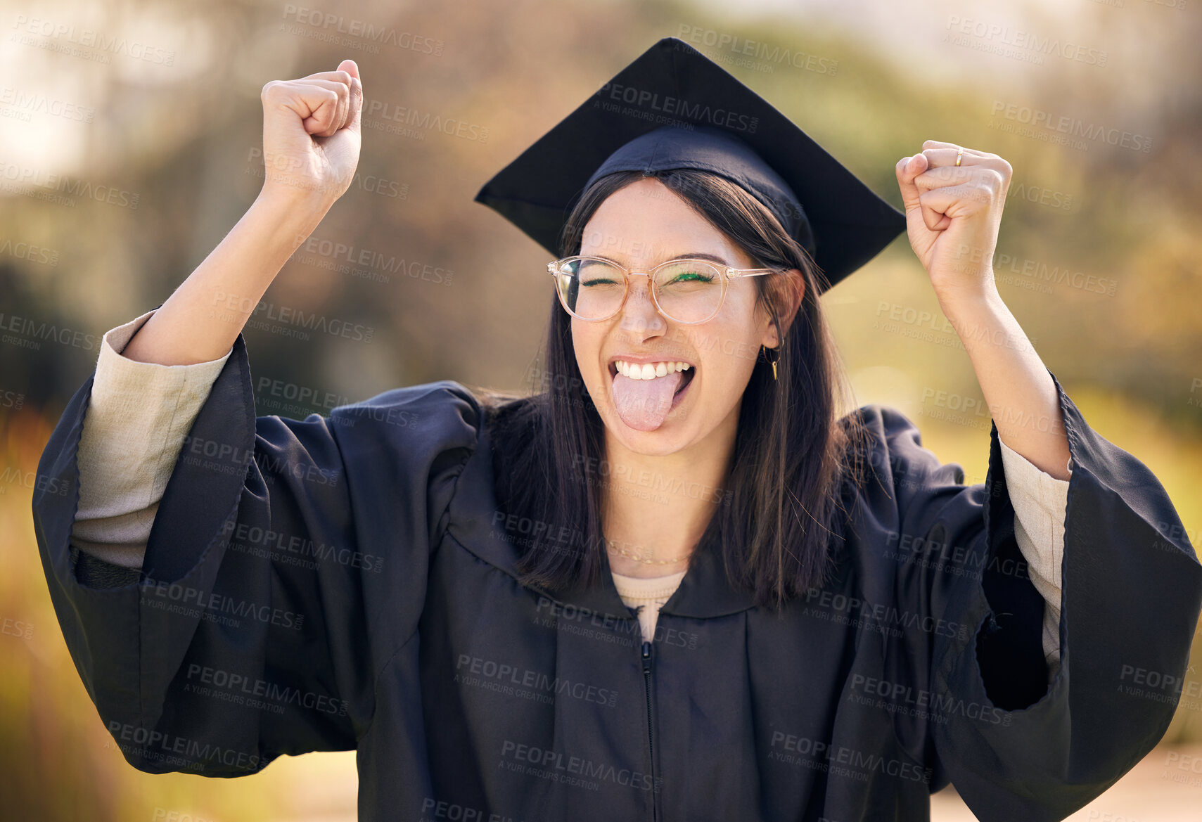 Buy stock photo Excited, college portrait and woman for graduation with wink and celebration for university milestone. Tongue out, achievement and female graduate in campus with success, education and goofy face