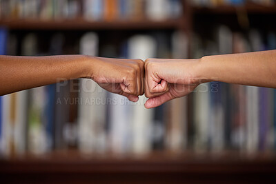 Buy stock photo University, education and students in library with fist bump, team project or knowledge on campus. College, support and people with hands together for collaboration, friends and studying at bookshelf