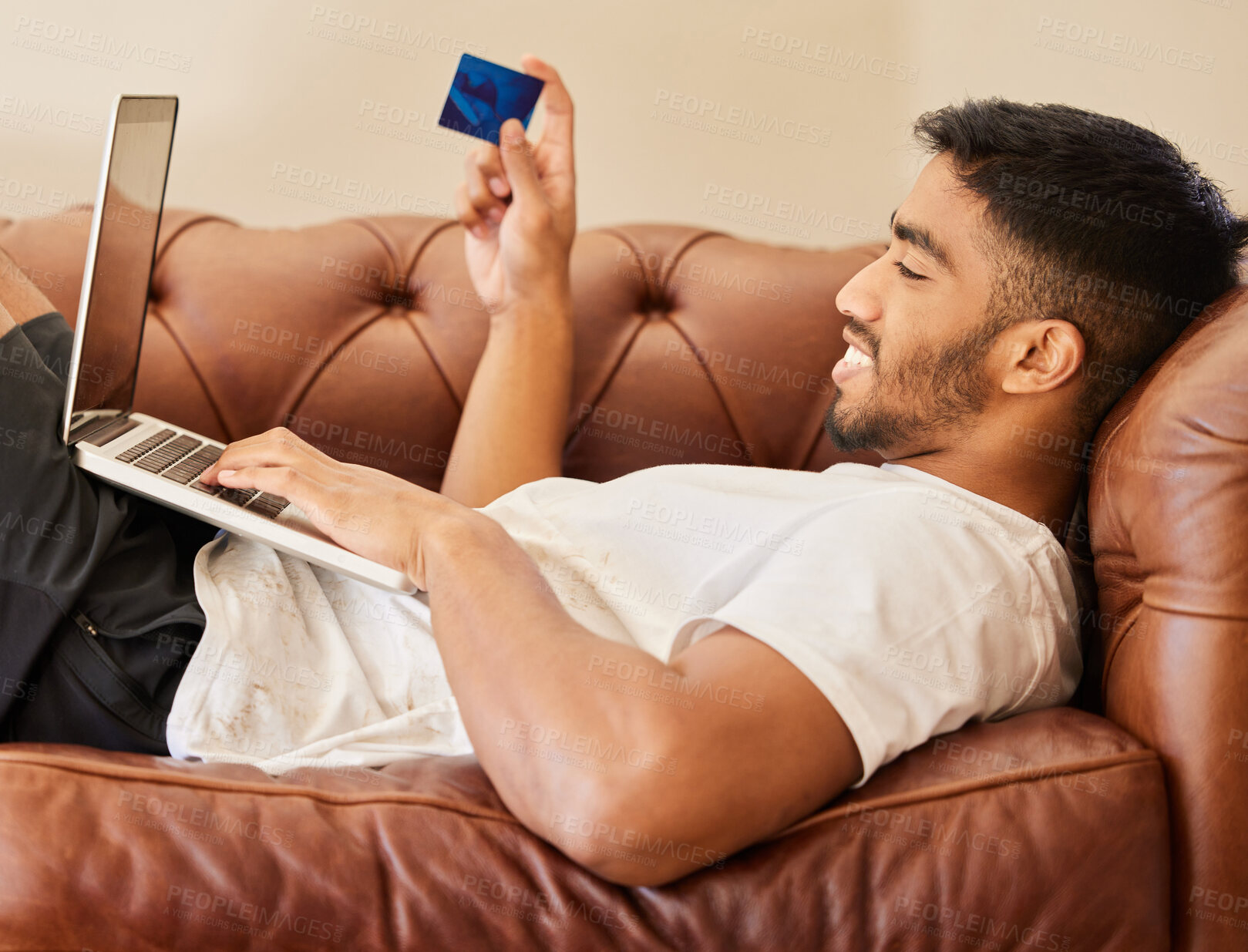 Buy stock photo Man on sofa with laptop, credit card and ecommerce with online shopping payment and fintech. Commercial, sale and shop website with male customer, smile with connectivity and internet banking at home