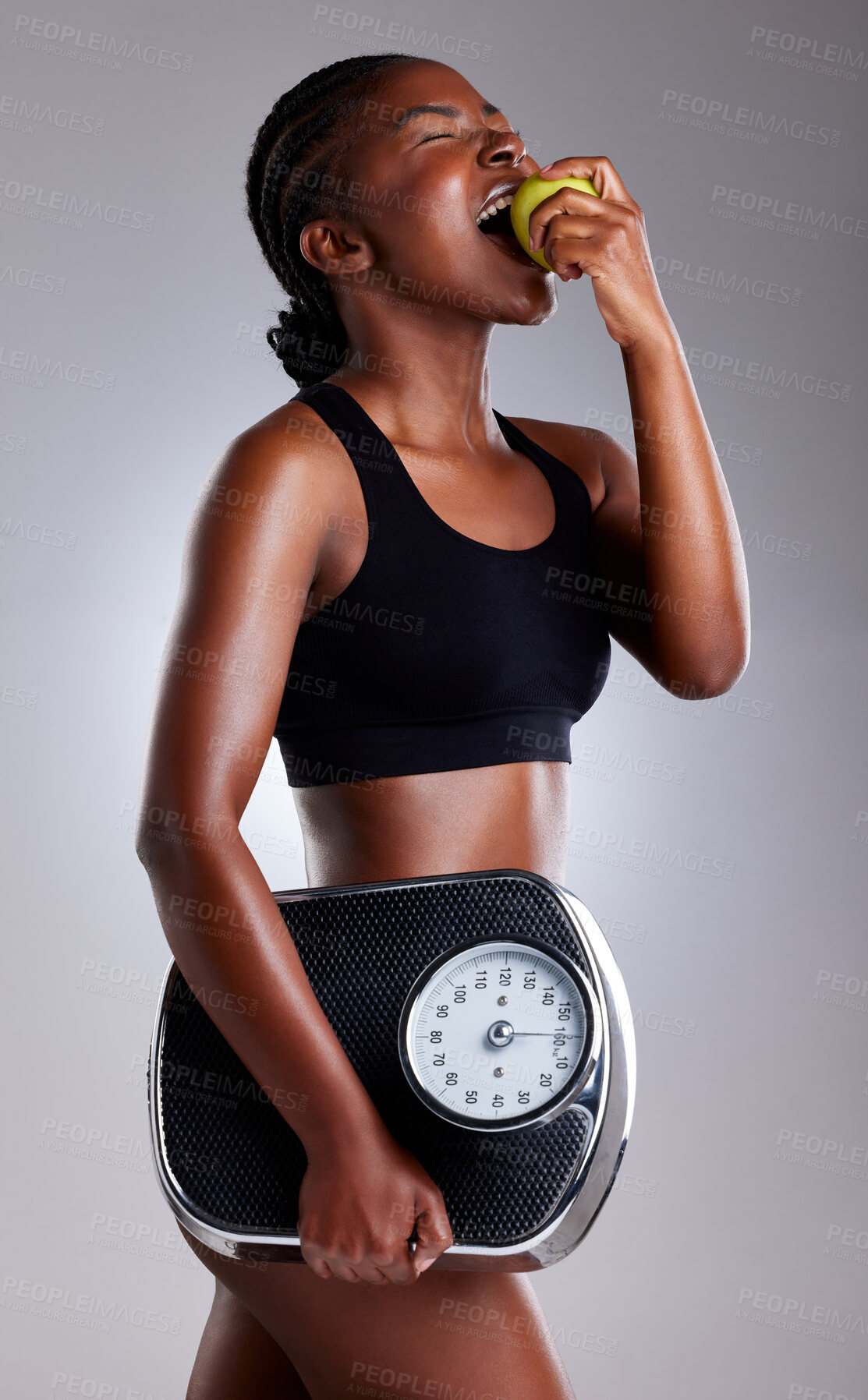 Buy stock photo Diet, scale and black woman eating apple for health, nutrition or body wellness isolated on white studio background. Hungry model, weight loss or fruit for organic food, vitamin c or fitness benefits