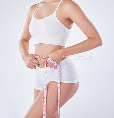 Buy stock photo Hands, underwear and model with tape measure on stomach for diet, nutrition or natural body. Lose weight, abdomen and slim woman check skin for health and wellness isolated on white studio background