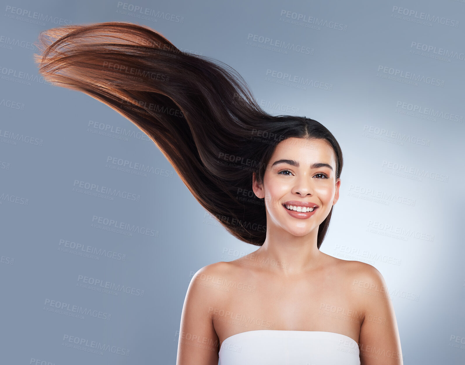 Buy stock photo Hair care, wind and portrait of woman in studio with natural, beauty and salon treatment. Smile, health and female person with shampoo shine for silky hairstyle by gray background with mockup space.