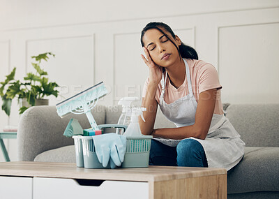 Buy stock photo Cleaning, tired and exhausted woman in a house to clean with supplies, detergents or tools. Young female or cleaner in a lounge with headache or stress in an apartment or room with fatigue or problem