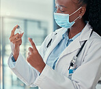 African american doctor wearing a covid mask. Medical professional holding bottles of covid vaccine. medical gp looking at vials of cure for corona virus. Specialist wearing a mask