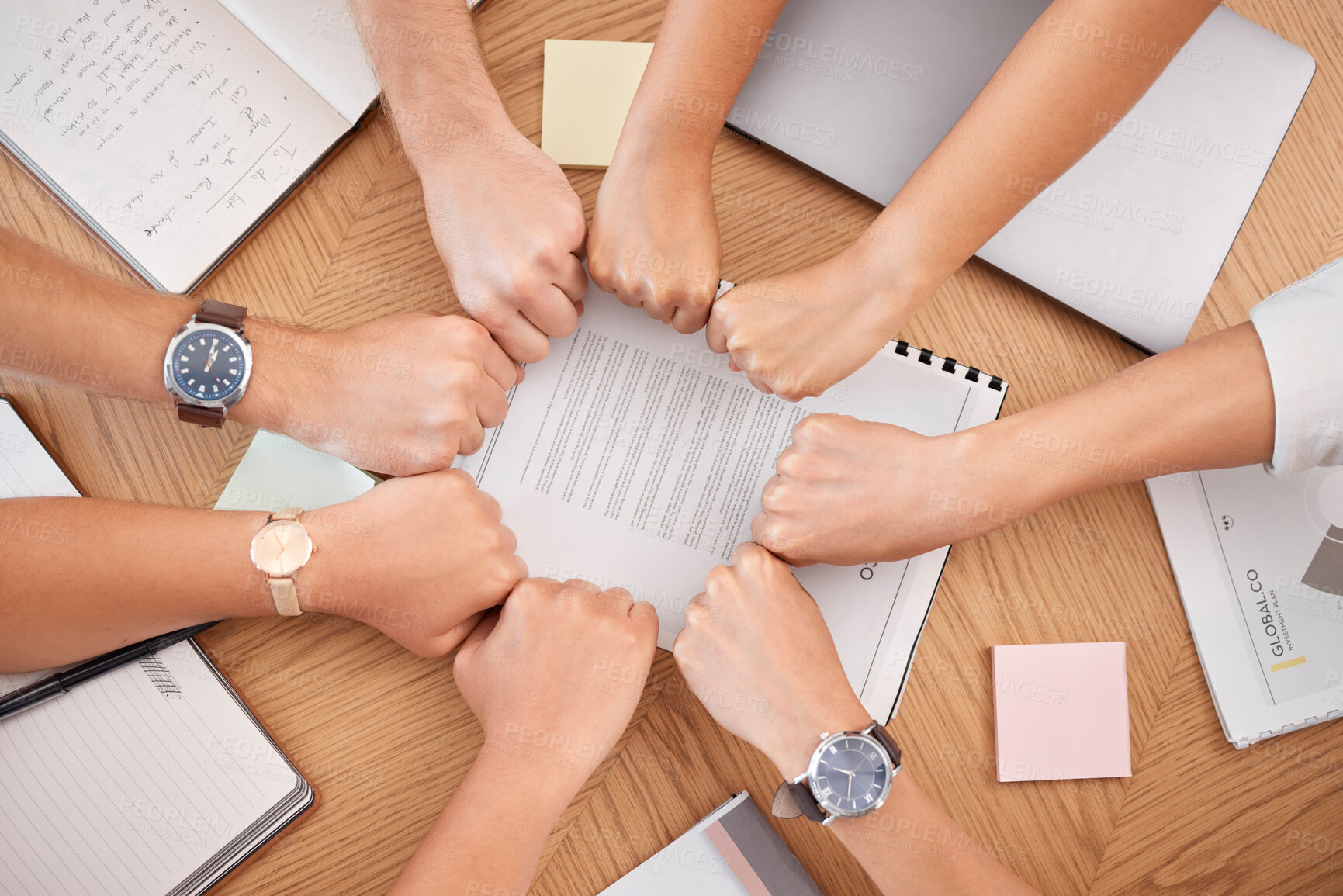 Buy stock photo Team hands, business meeting and fist for collaboration or motivation support at office desk. Diversity, corporate  teamwork strategy and professional partnership trust success planning in workplace