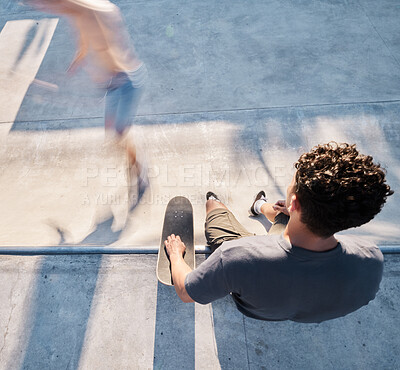 Buy stock photo Skate park, top view and man with a skateboard in the city street for fun or sports training. Skating, fitness and young male skater sitting on a ramp before practicing to skate in an urban town. 