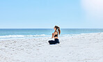 Yoga, woman and outdoor at beach, on sand and meditation for wellness, relax and peace. Young female, healthy lady and calm for exercise, pilates and fitness for balance, seaside vacation and health.