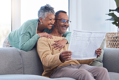 Buy stock photo Love, senior couple and reading newspaper, story or news article in living room home. Retirement, relax time and happy elderly man and woman embrace in house, hugging or cuddle together and bonding.