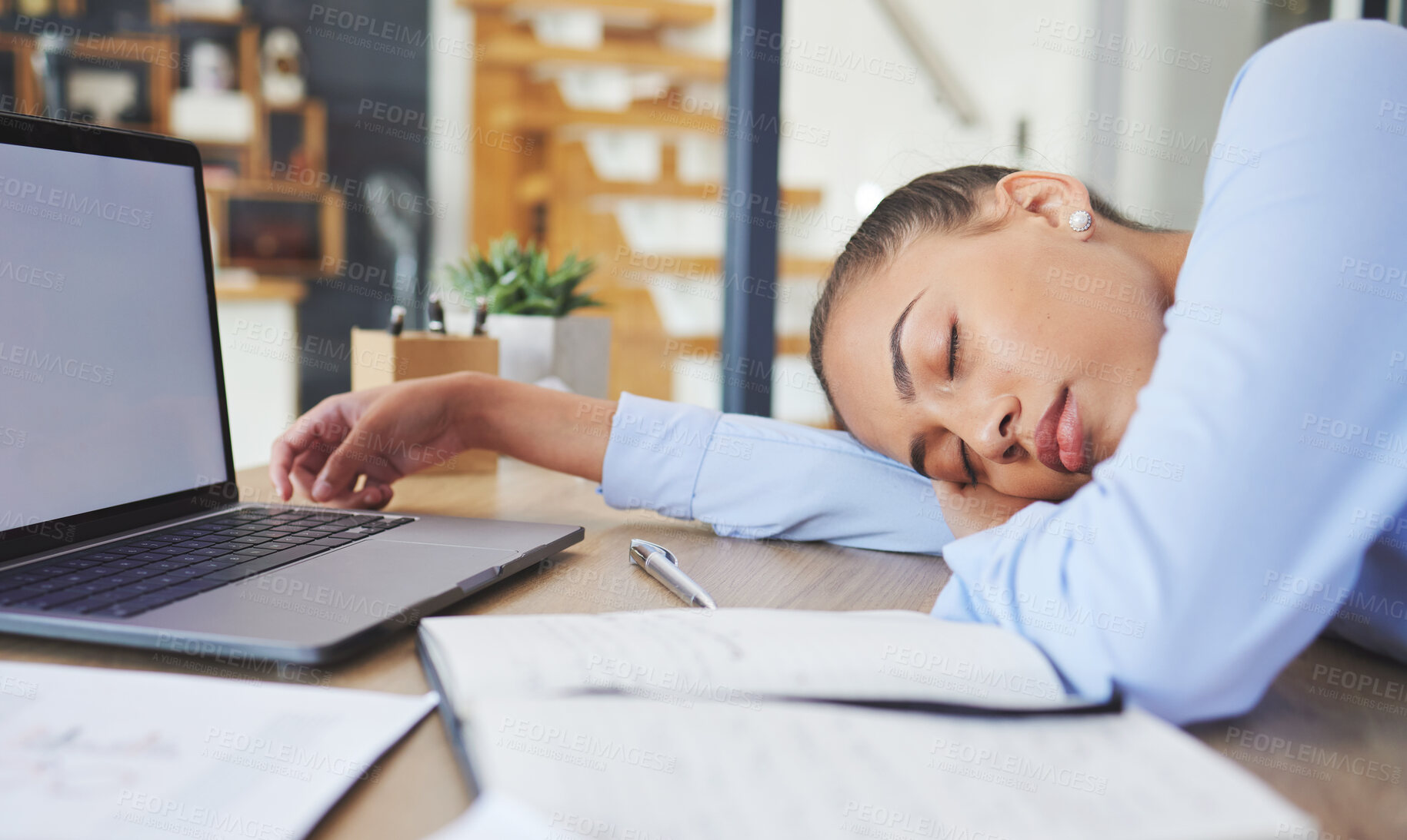 Buy stock photo Tired, exhausted and business woman sleeping at her desk while working in a modern office. Burnout, sleepy and professional corporate employee taking a nap while planning a project at her workplace.