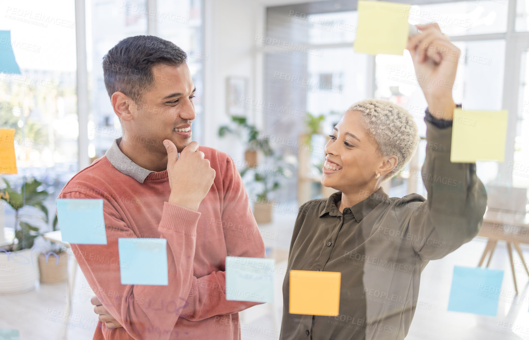 Buy stock photo Creative people, planning schedule and smile for team strategy in brainstorming on glass wall at office. Happy man and woman employees in project plan, tasks and sticky note or startup