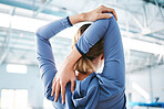 Back, stretching arm and woman at gym for health, fitness and wellness. Sports, athlete and person warm up, stretch and getting ready for workout, training or exercise for flexibility or strength.