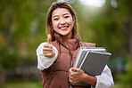 Student, thumbs up and portrait of woman with books for learning, education and outdoor on university campus with happiness or pride. Happy, face and girl in college with notebook or walking to class