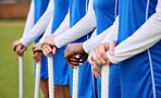 Teamwork, sports and hockey with hands of people on field for workout, challenge and support. Fitness, competition and training with closeup of women at tournament for health, community and exercise