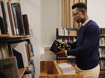 Buy stock photo Librarian man, shelf and book with thinking, packing or stock for admin, organized and ideas in workplace. African employee, university or library expert with research, book and reading at workplace