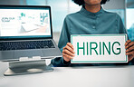 Person with hiring sign, laptop and human resources with offer, recruitment and job opportunity at company. Onboarding, pc screen with website and HR invitation to join team, poster and recruiting