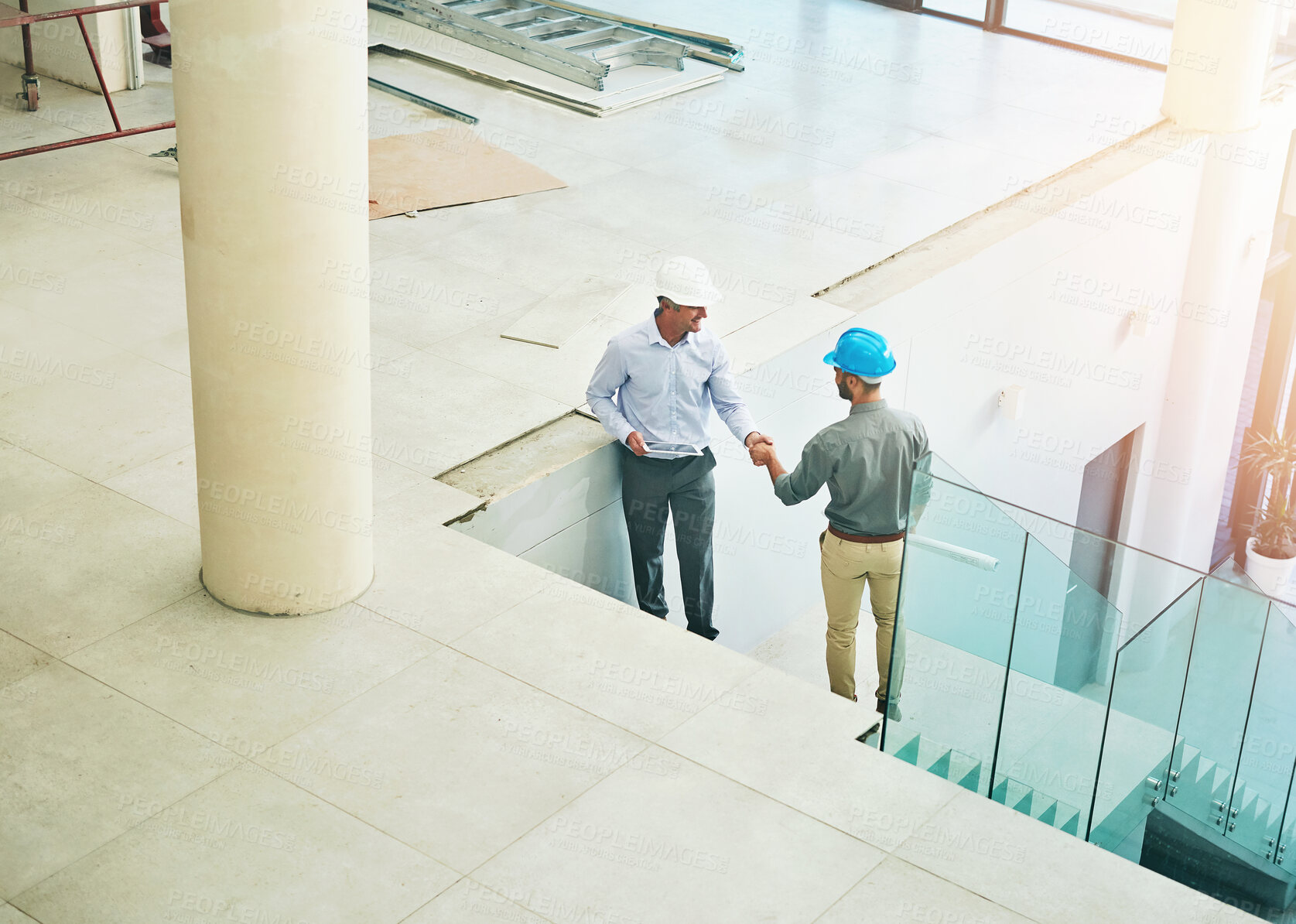 Buy stock photo Handshake, deal and architect in building with partnership for contract or project success. Shaking hands, trust and engineer for design by workplace site on stairs with collaboration or teamwork