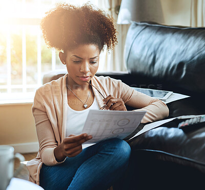 Buy stock photo Banking, paperwork and black woman in home with bills, document and reading investment report. Wealth, savings or person plan future with student loan, info and budget for tax with finance strategy
