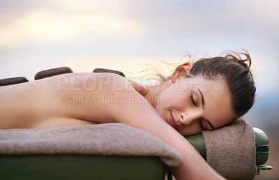 Buy stock photo Relax, hot stone and woman outdoor by spa for wellness treatment with luxury resort on summer vacation. Bed, zen or beauty salon and female customer eyes closed for stress relief with calm therapy.