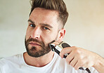 Man, portrait and electric trimmer in home bathroom for grooming, skincare or morning routine for wellness. Face, shaving beard and person cleaning for beauty, health or hair removal for hygiene