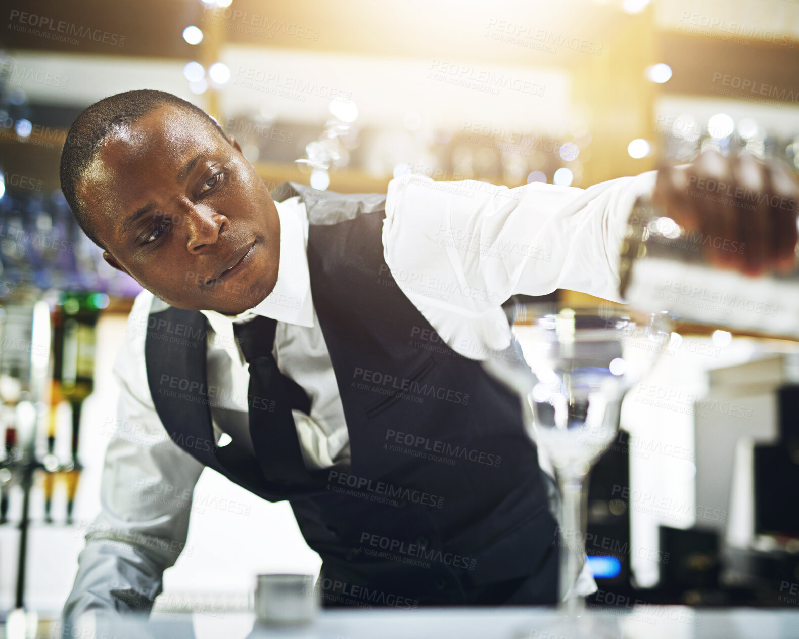 Buy stock photo Black man, bartender and prepare drink in restaurant, hospitality and counter server for alcohol. Mixing cocktail, martini at winery or hotel bar, waiter with confidence and professional barman