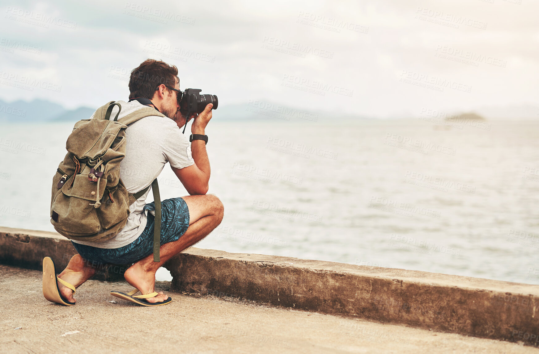 Buy stock photo Man, camera and photography at ocean as travel blogger for picture memory for creative, digital or lens. Male person, equipment and shoot in Thailand for nature trip as photographer, view or artist