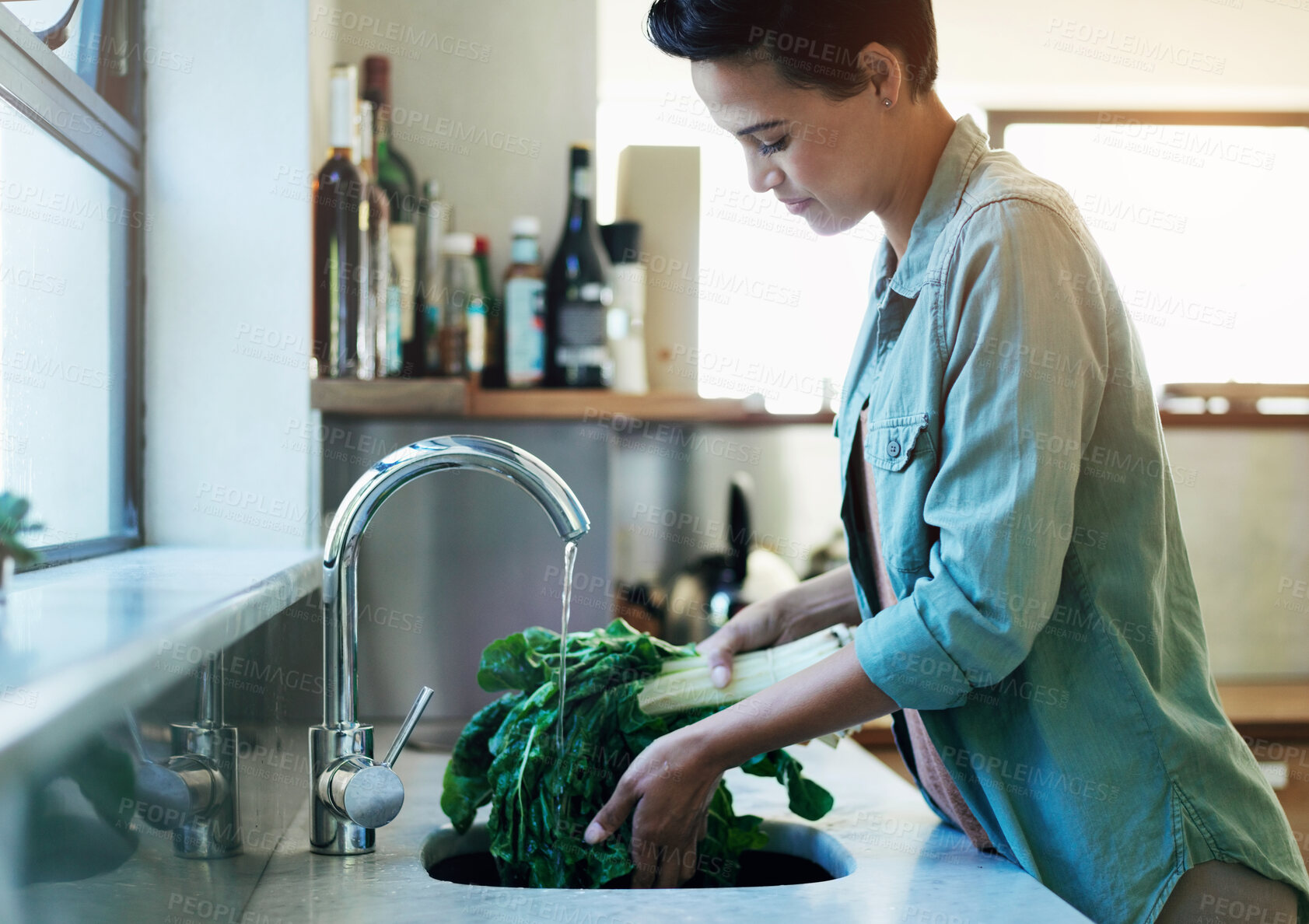 Buy stock photo Rinse, vegetables and woman in kitchen, nutrition and sink with water, wellness and prepare for healthy meal. Person, home and girl with ingredients, cleaning and hygiene with food, splash and diet