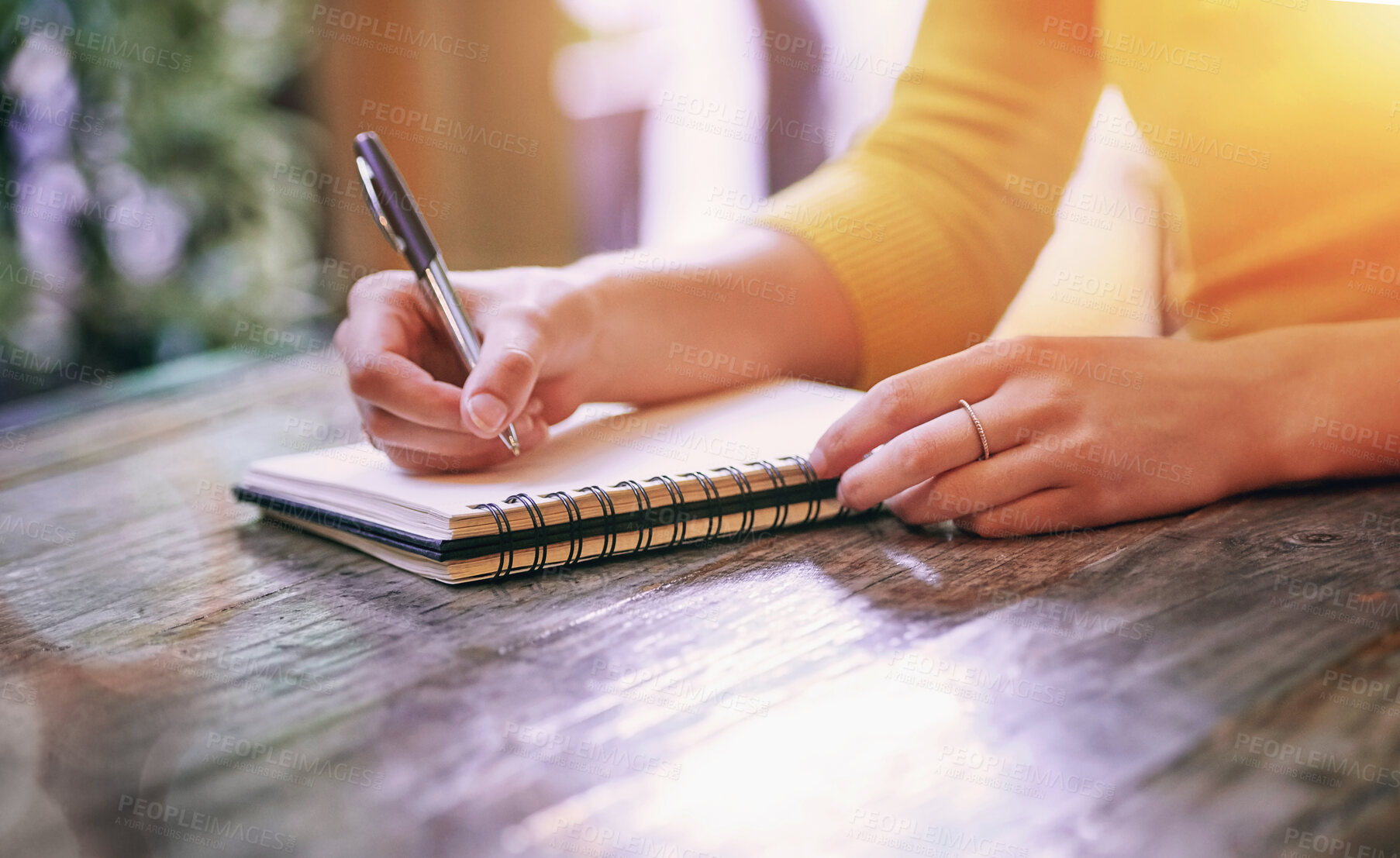 Buy stock photo Woman, closeup and notebook for notes, schedule and planning on table in cafe with pen. Wife, writing and notepad with diary, marriage journal and letter for self care, growth and relationship goals