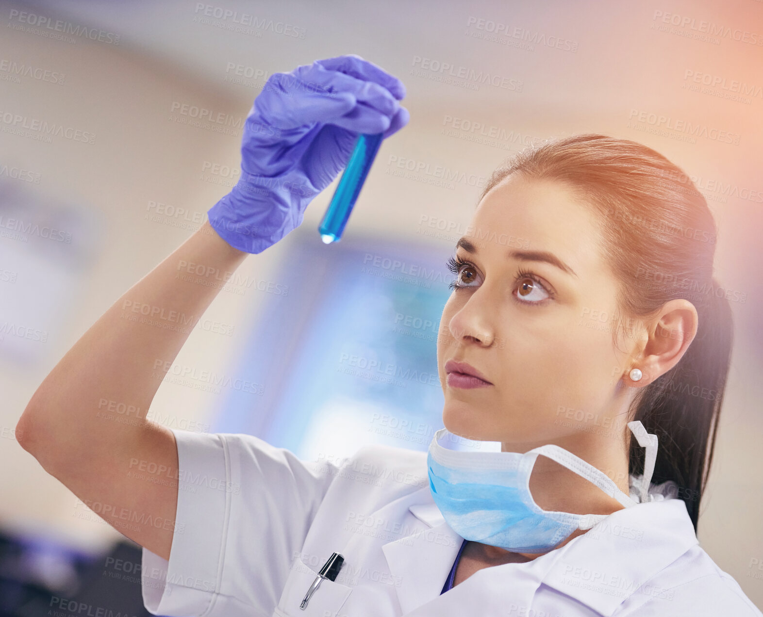 Buy stock photo Scientist, liquid sample and woman in laboratory with face mask for investigation, research or vaccine testing. Lens flare, cure and person with test tube for analysis, experiment or medical study