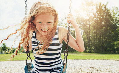 Buy stock photo Girl, portrait and smile with park, swing and nature for outdoor fun and play with fresh air. Child, tree and playground with summer, freedom and school holiday or break outside with happiness