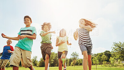 Buy stock photo Happy children, summer and running with friends in nature for fun, playful day or sunshine at park. Diversity or group of excited kids or youth enjoying sunny outdoor holiday on grass field together