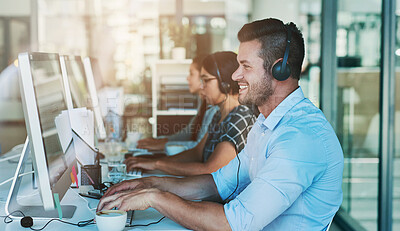 Buy stock photo Call center, telemarketing and man at computer with customer service and crm work. Conversation, smile and phone consultant at a coworking office with headset and operator with web advice at desk