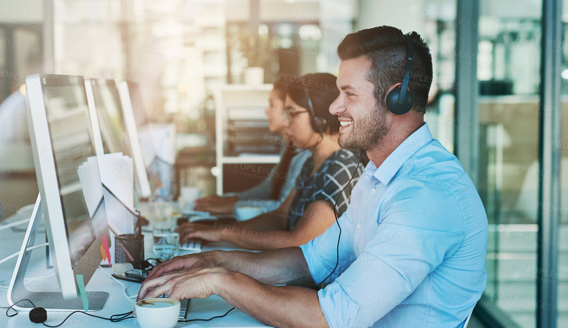 Buy stock photo Call center, telemarketing and man at computer with customer service and crm work. Conversation, smile and phone consultant at a coworking office with headset and operator with web advice at desk