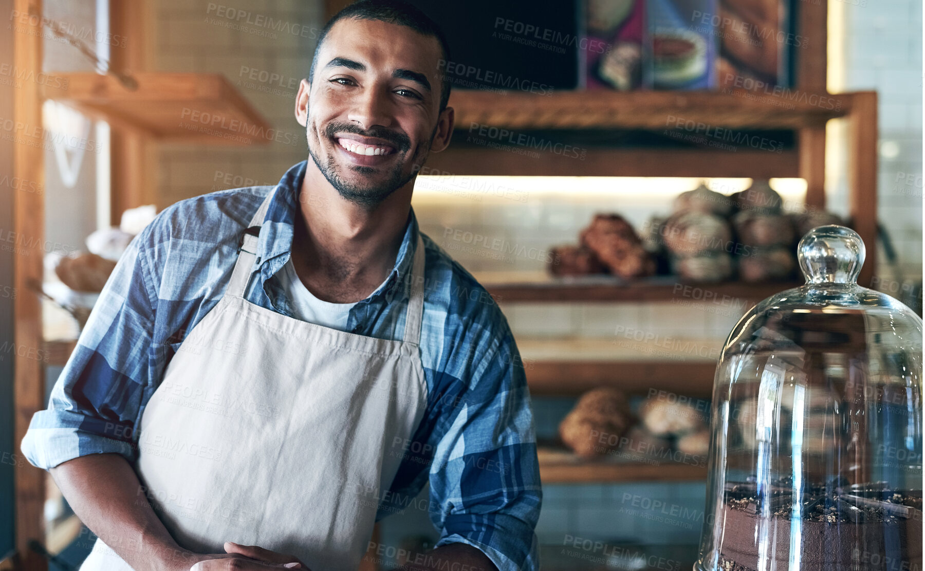 Buy stock photo Cafe, portrait and happy man waiter in bakery for store welcome, help and friendly hospitality service. Retail, startup and coffee shop or restaurant server with cake, cookies or counter assistance