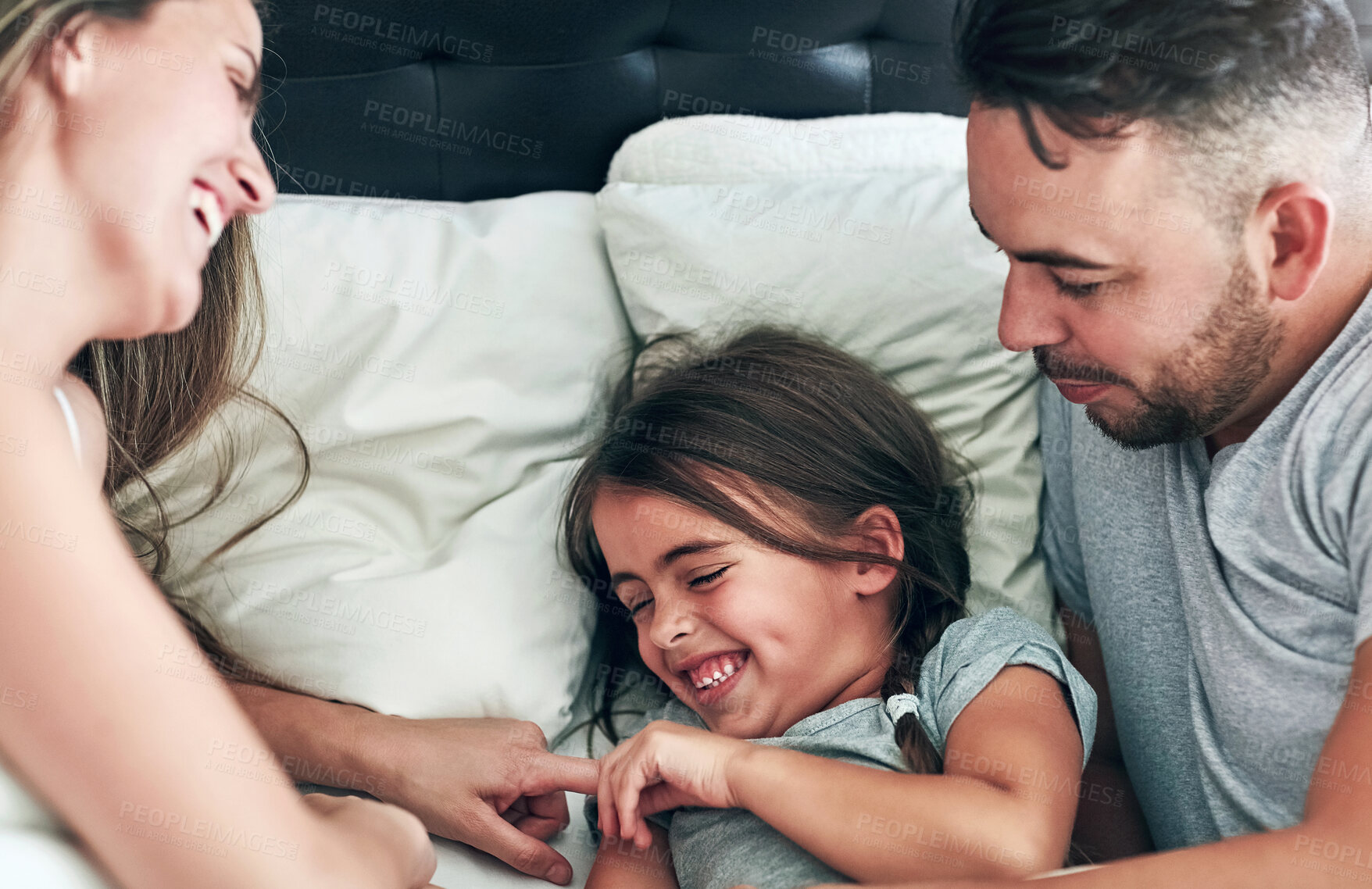 Buy stock photo Love, laughing and happy family in bed for tickle fun, playing or bonding at home together. Support, security and girl with funny parents in bedroom for wake up games with safety, care or protection 