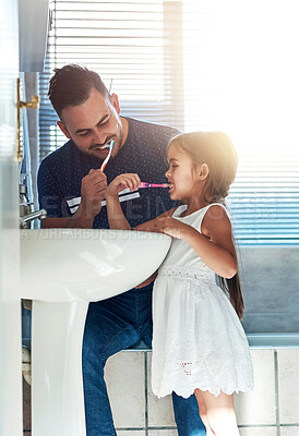 Buy stock photo Father, girl and brushing teeth in bathroom, oral health and learning mouth hygiene in home. Daddy, daughter and teaching dental care for child development, toothbrush and cleaning plaque on morning