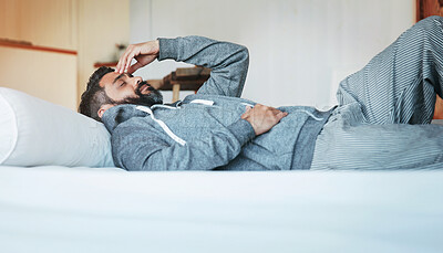 Buy stock photo Tired, sleep and man in bed with headache, stress and mental health burnout in home. Fatigue, insomnia and person with depression, anxiety or migraine in bedroom to relax, rest or thinking in morning