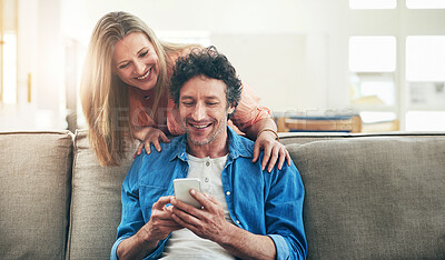 Buy stock photo Mature, couple and happy on sofa with phone for reading online news, social media scroll and embrace in home. People, hug and laughing with smartphone for funny meme, bingo or digital gaming on couch